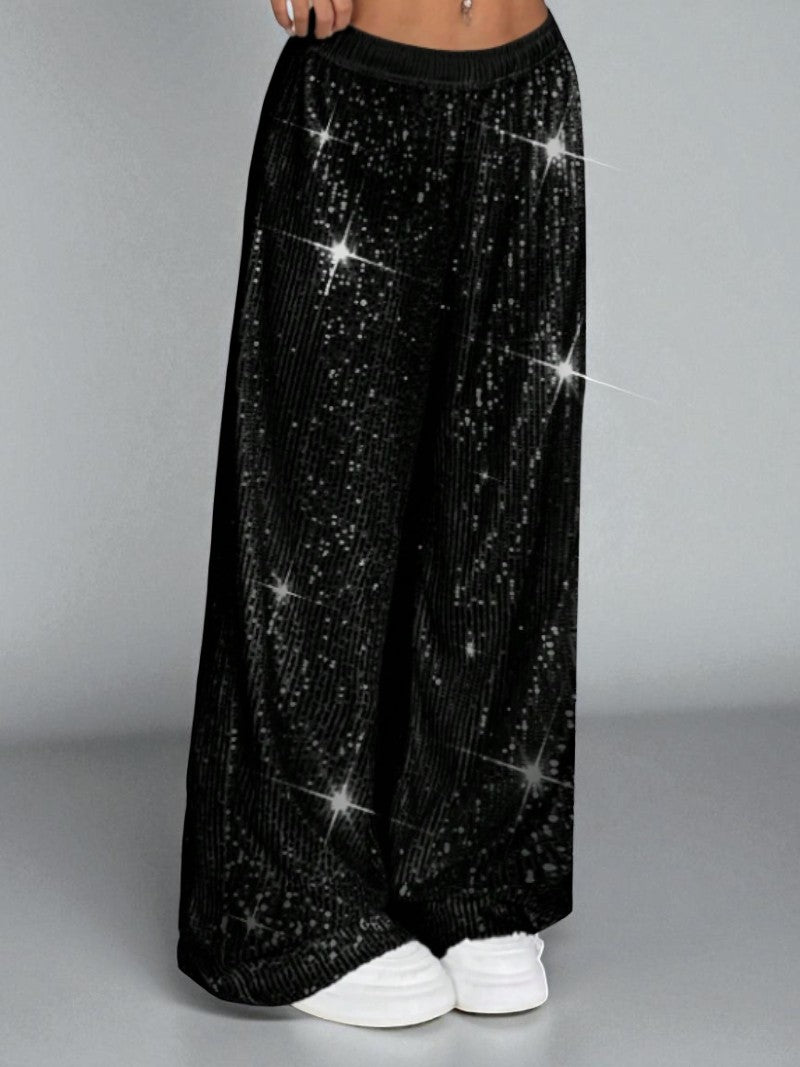 Black sequin pants on a plain background